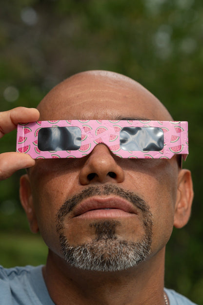 Close portrait wearing Tember Watermelon solar eclipse glasses